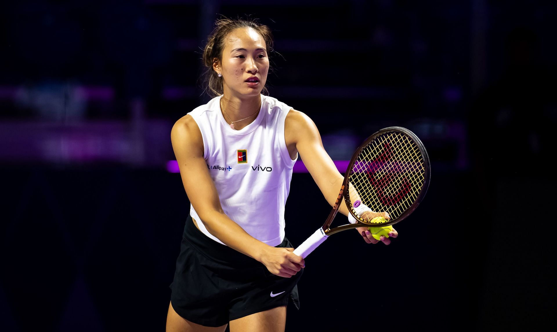 Zheng Qinwen prepares to serve during a practice session. (Getty)